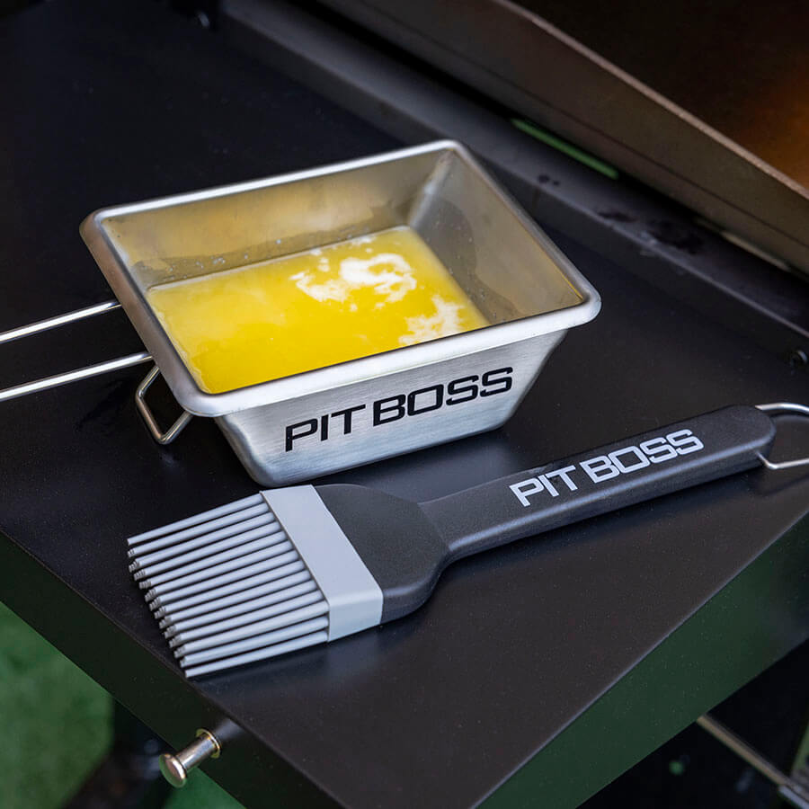 Lifestyle shot of butter inside griddle sauce pot sitting on griddle side table next to brush.