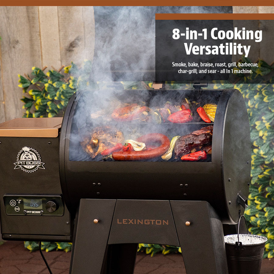 Meats and veggies grilling on both racks of the black barbecue. Smoking coming out of the grill. The barbecue is in a backyard setting.