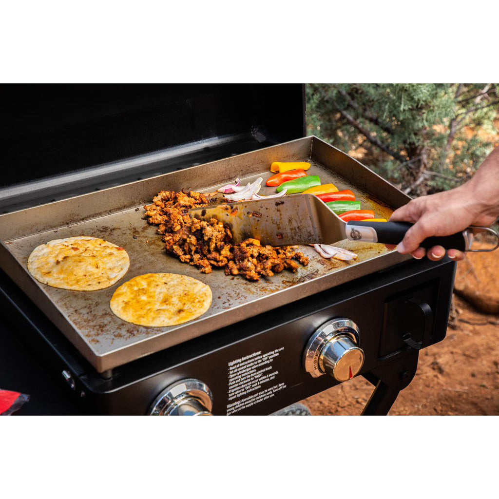 lifestyle of cooking fajitas on griddle in woods