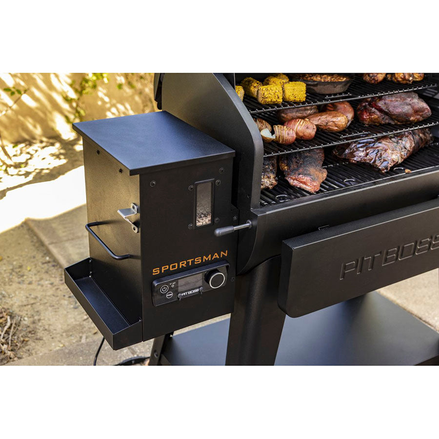 Digital control board displayed on the grill outside. Smoked meats and veggies  in the grill.