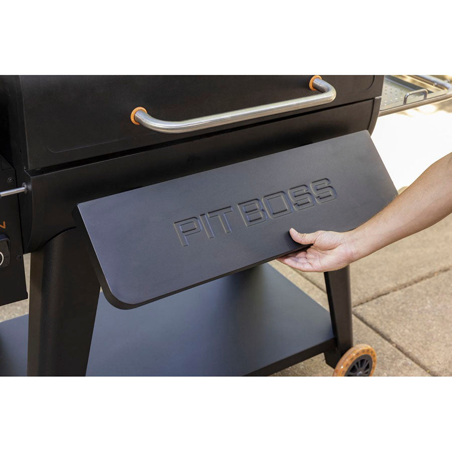 Pit Boss Sportsman 1600 Wood Pellet Grill. Mans arm opening the grill table.