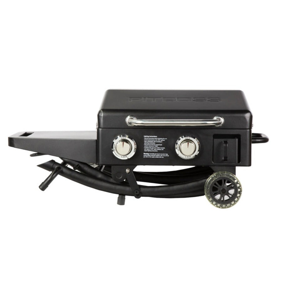 lifestyle_2, All black griddle with silver accents and white lettering w engraved Pit Boss logo. Folded up to be portable