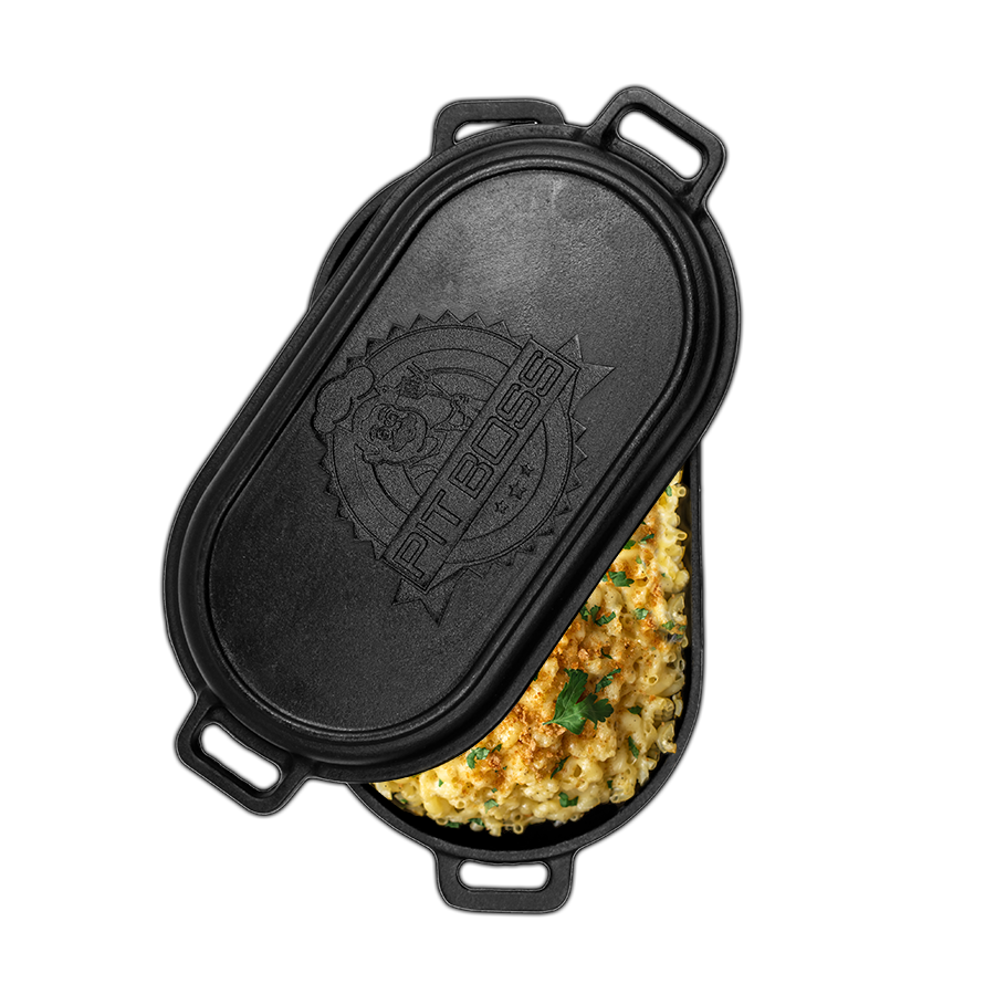 cast iron lid slightly open to reveal roaster full of mac and cheese
