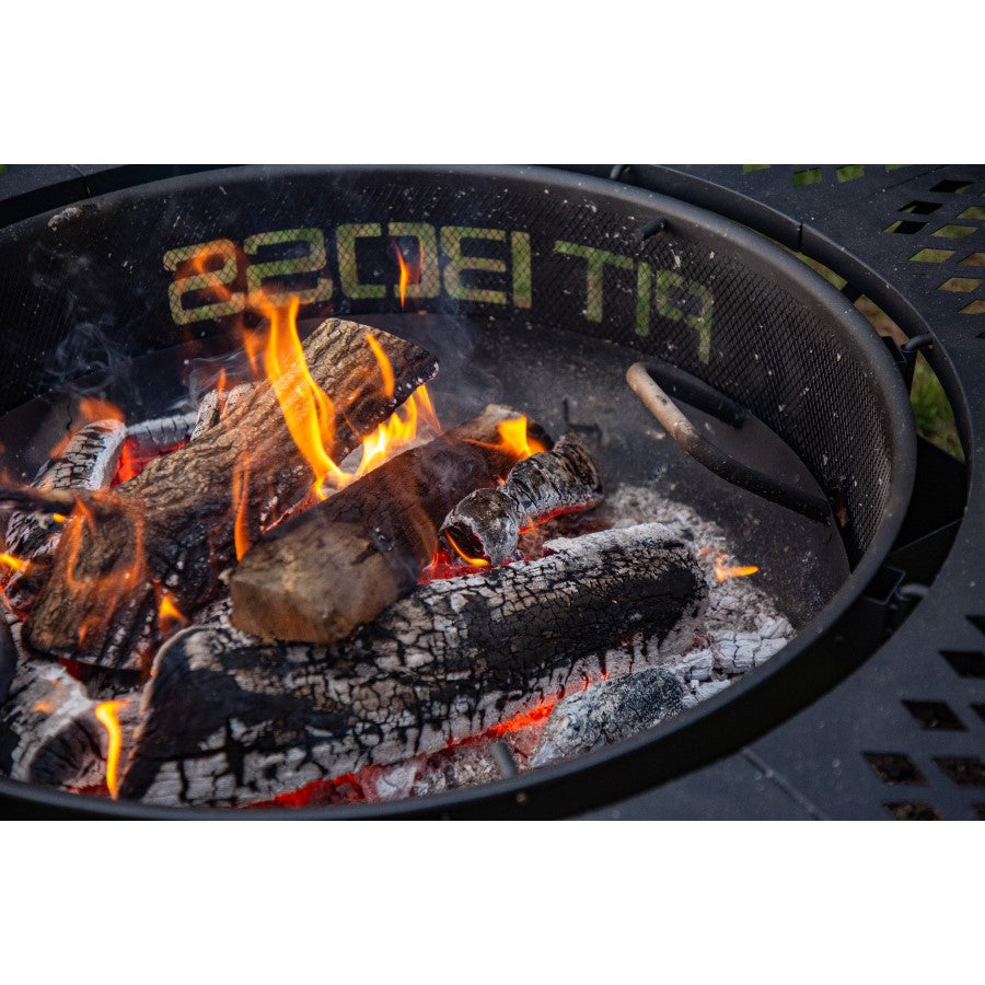 lifestyle_2, Black fire pit with round shape and black lettering: Pit Boss. Close up of fire in fire pit