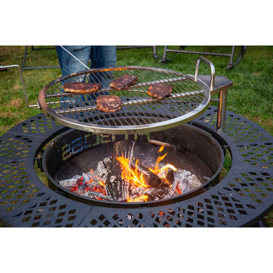 lifestyle_3, Black fire pit with round shape and black lettering: Pit Boss.  Shot of meat cooking on grate above fire pit