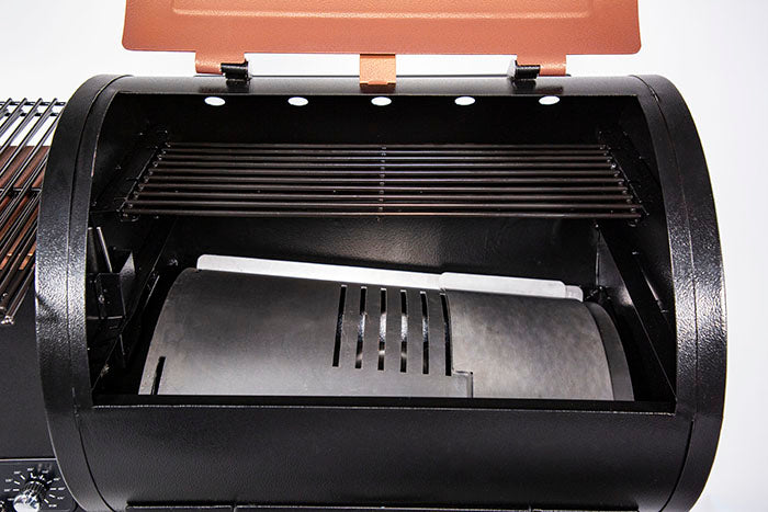 lifestyle_1, Orangeish-brown and black grill with silver accents and Pit Boss logo. Close look at inside cooking grates and frame broiler plates