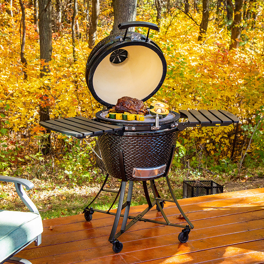 lifestyle_2, All black grill with bumpy texture and silver accents. Shown in backyard with fall colors grilling meat and veggies