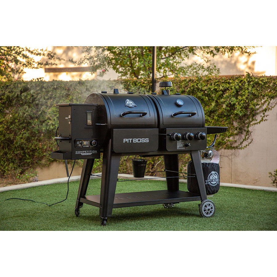 lifestyle_4, Black grill with silver accents and Pit Boss logo and lettering. Shot of grill in backyard