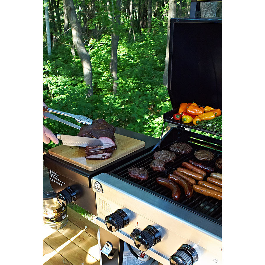 lifestyle_1, cutting board magnetized to side of grill while meat is cut on it
