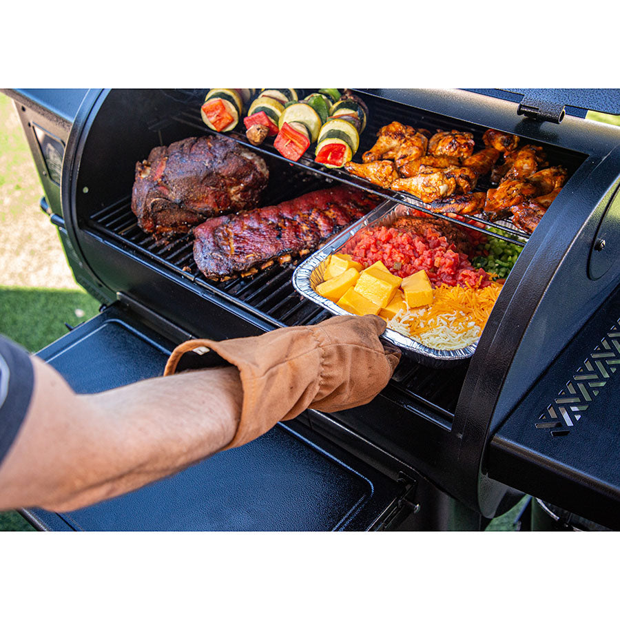 using gloves to pull a foil tray out of grill